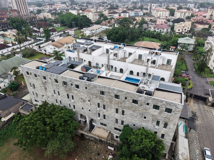 Aerial view of completed residential development with rooftop pool